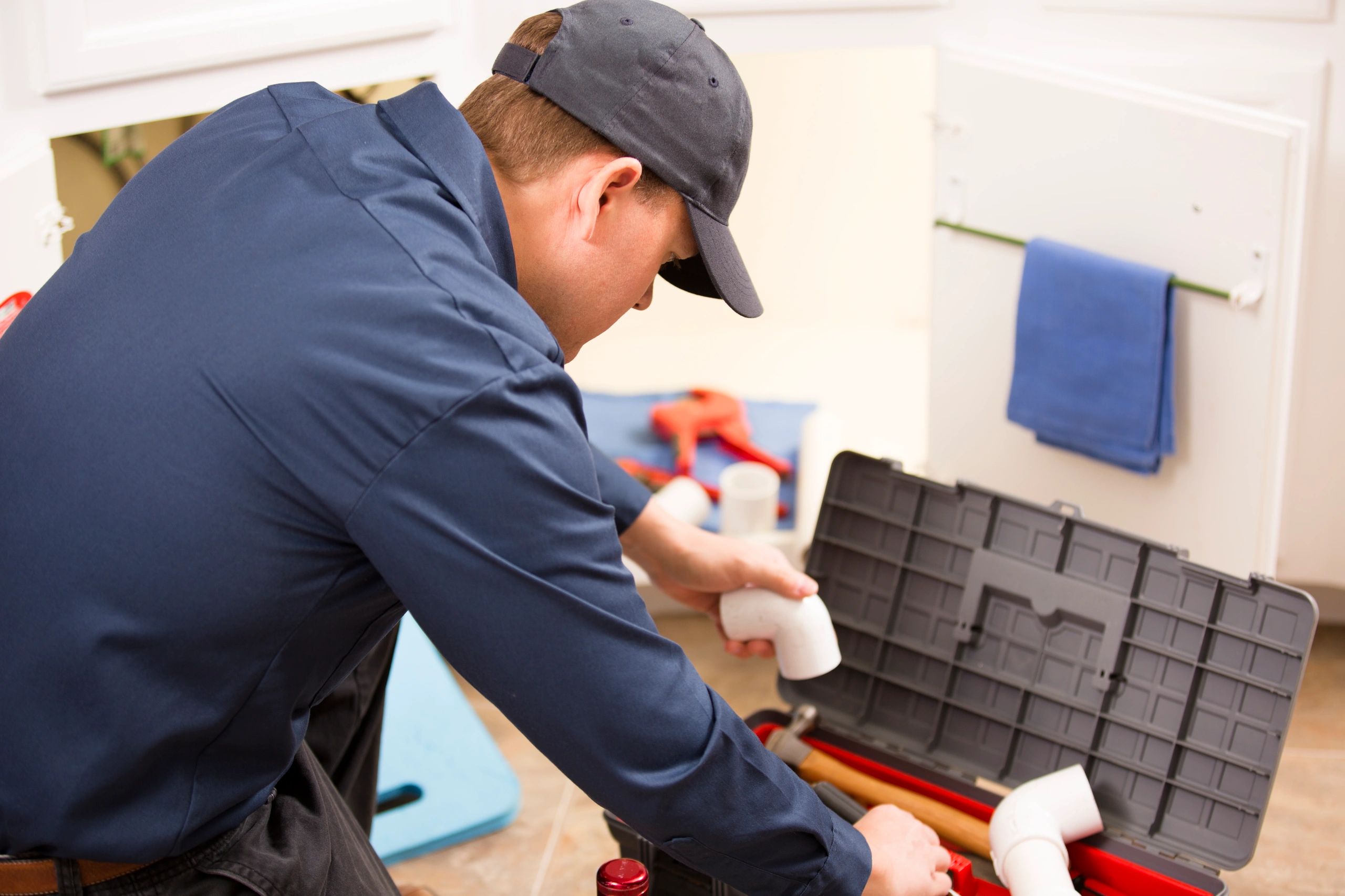 Plumber working on pipes